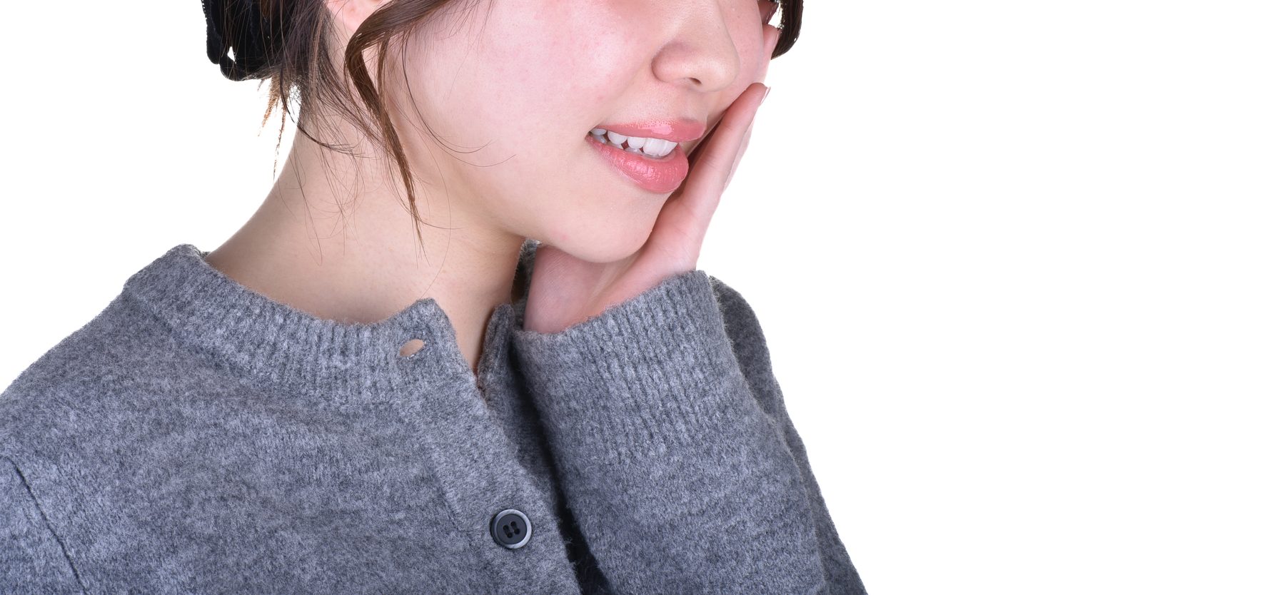 Woman with toothache holding her jaw — emergency dentist in Nagoya