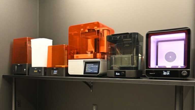 Row of in-house 3D printers, a wash unit and a post-curing chamber in the digital dental laboratory where retainer models are produced | Eden Dental Office Nagoya