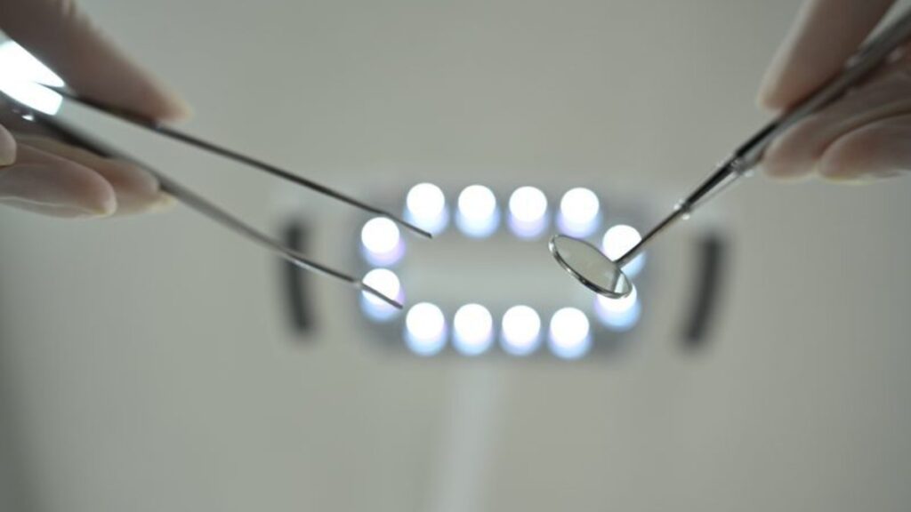 Dental mirror and instruments during a close-up enamel examination under the operating light | Eden Dental Office Nagoya