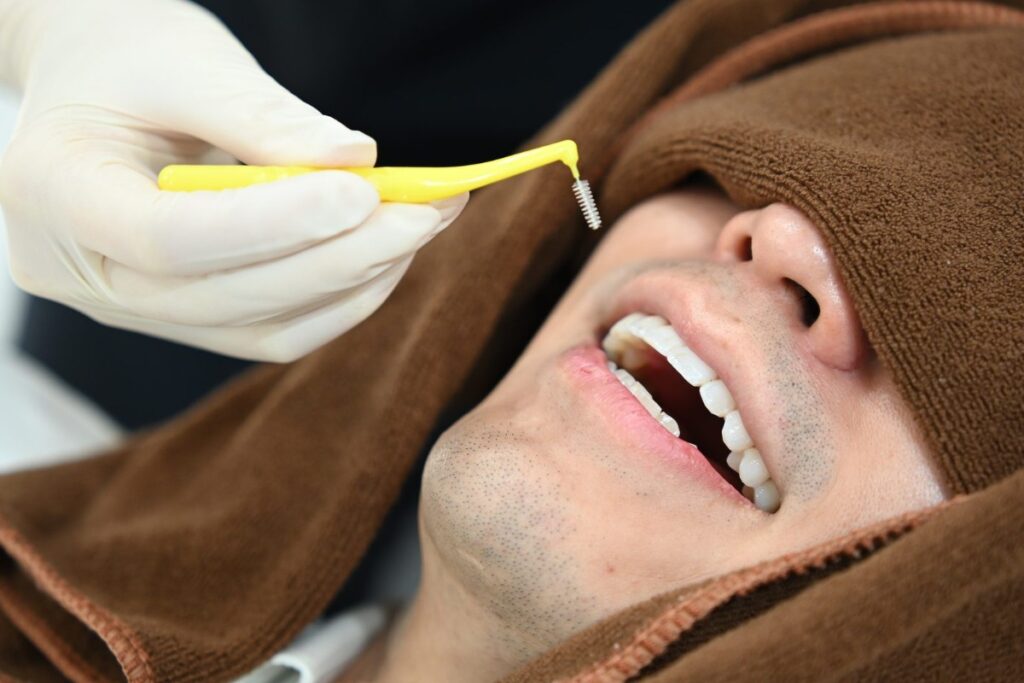 Interdental cleaning during a maintenance appointment, the visit a whitening touch-up is timed to follow | Eden Dental Office Nagoya